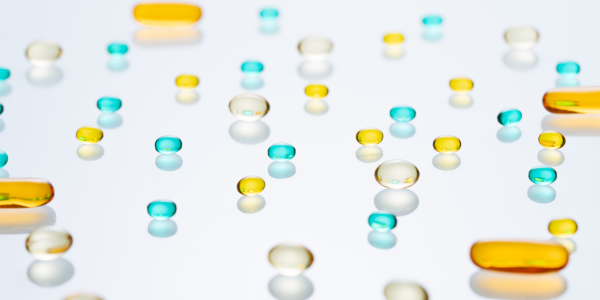 clear, yellow and blue gel filled pills on a transparent background