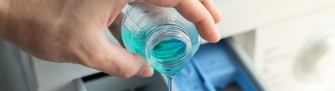 Man pouring concentrated washing machine liquid