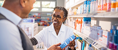img title A pharmacist helping a customer shop for topical solutions off the shelf.